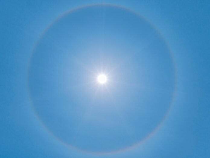 blue sky with white sun