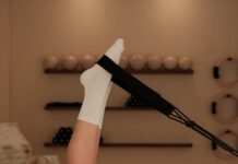 필라테스, 몸과 마음을 동시에 단련하는 현대인의 건강 비법 Woman does pilates exercise on a reformer machine.