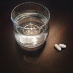 “식단+보충제, 건강 지키는 새로운 습관으로 자리잡다” two oval white medication tablets on brown surface