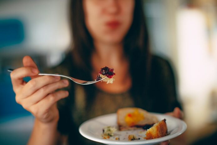 Photo by Helena Lopes woman holding plate of cake