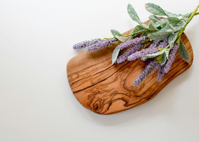 Photo by Davies Designs Studio green and purple leaves on brown wooden chopping board