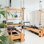 필라테스 스튜디오 창업의 현실: “나도 강사 한번 해볼까?” 취미가 직업이 될 때 고려해야 할 것들 a room filled with lots of machines and a plant