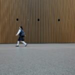 일상 속에 스며드는 웰니스 문화, 건강 트렌드와 실천법 woman in uniform walkin on gray concrete pavement during daytime