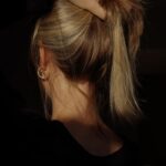 두피부터 모발까지, 건강한 헤어 관리법 최신 트렌드로 실천하기 a woman with her hair in a bun