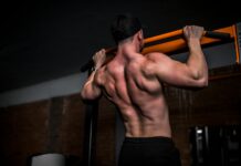 우리 몸의 엔진, 근육을 지키는 일상 루틴의 변화 topless man in black shorts holding orange bar