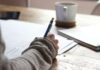 바쁜 일상 속, 내 마음을 지키는 ‘마이크로 멘탈 케어’가 뜬다 person writing on brown wooden table near white ceramic mug